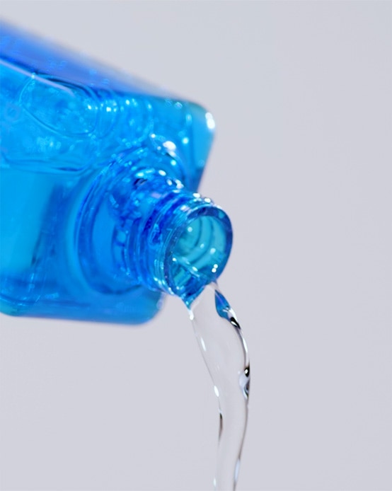Vital Hydra Solution toner liquid essence pours out of the blue bottle