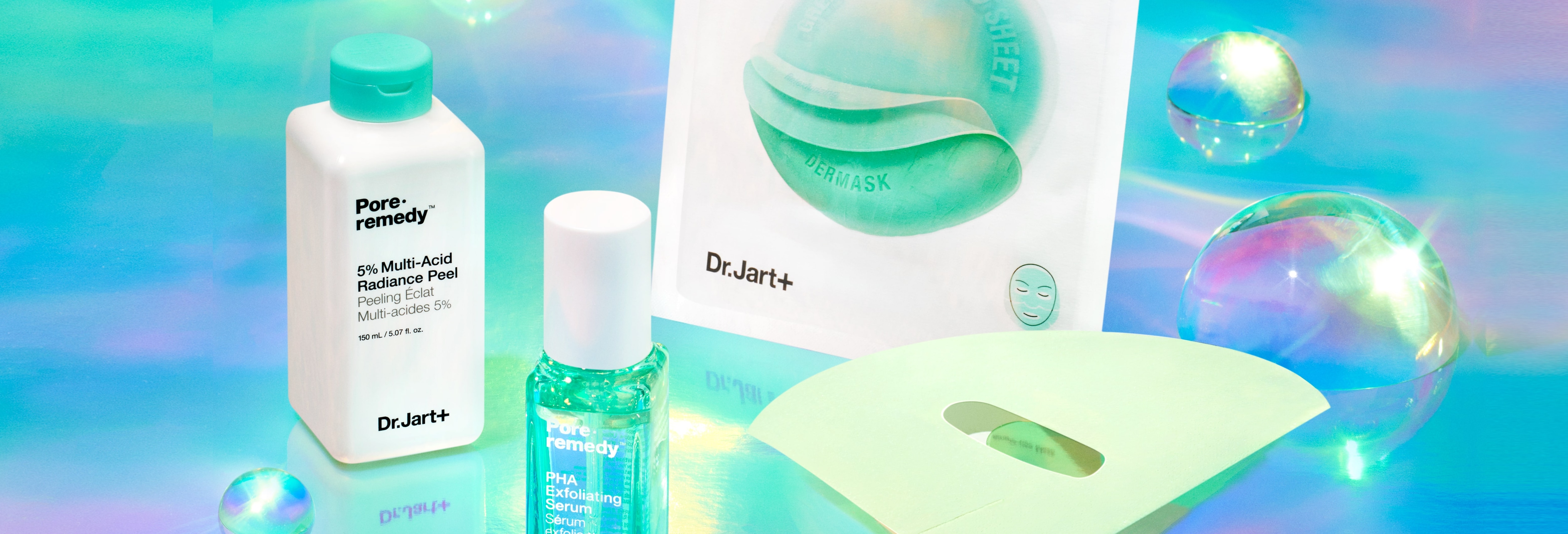 Dr.Jart+'s collection of skincare exfoliators for dullness and unclogging pores are displayed on a blue reflective background