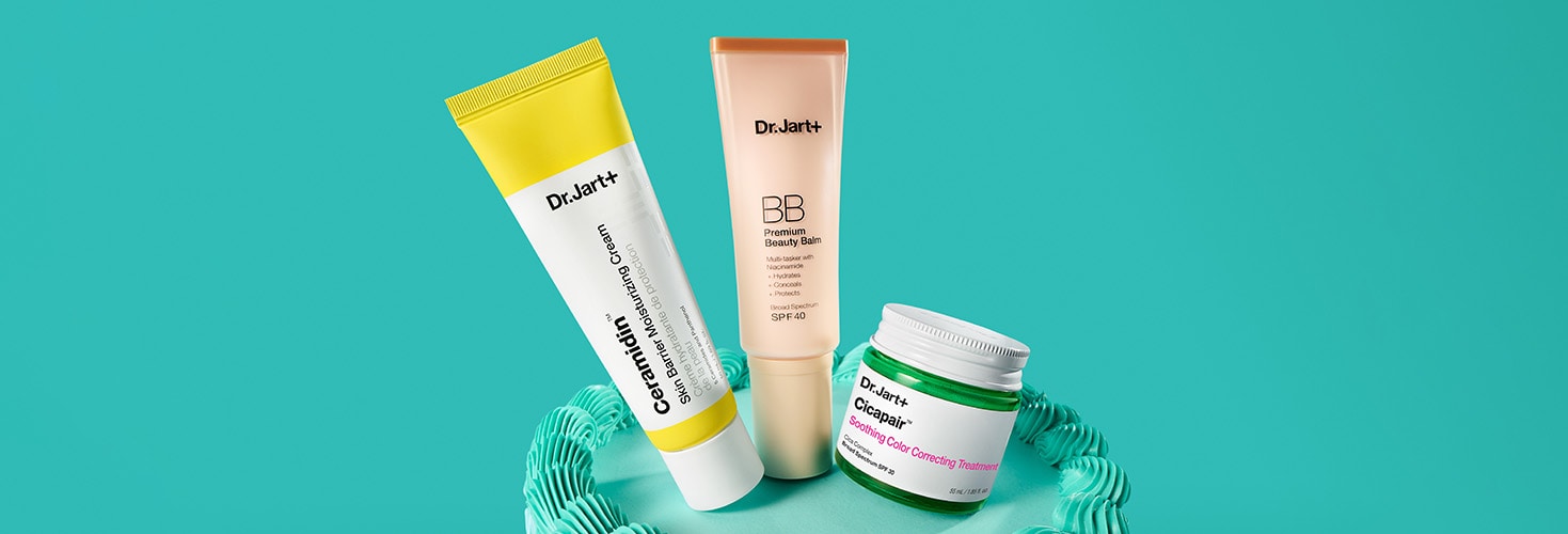 Dr. Jart+ color correctors & moisturizer are displayed atop a birthday cake. 
