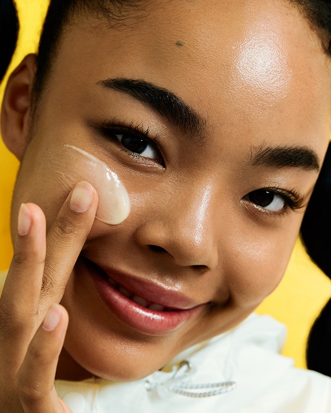 Woman applies Ceramidin Serum Toner to cheek