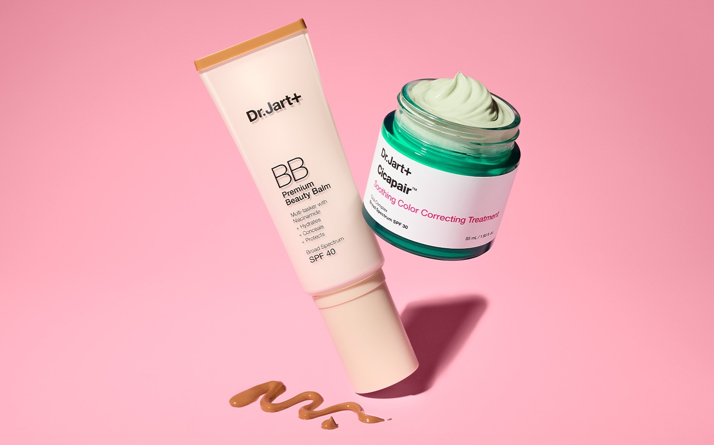 Dr Jart BB Cream & Color Corrector are on a pink background and opened to show texture of both formulas.
