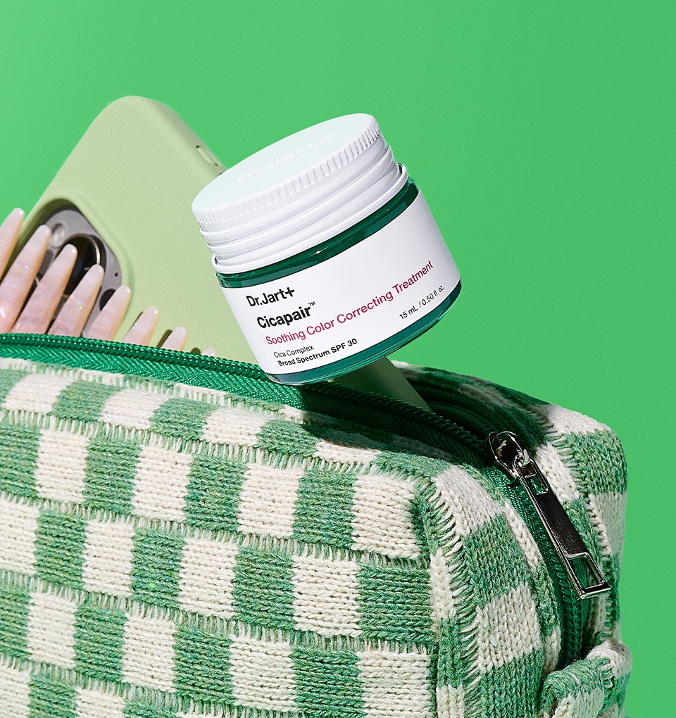 Dr. Jart+ Cicapair color corrector is displayed popping out of a travel bag.