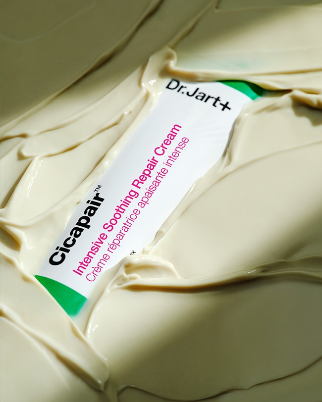 Cicapair Moisturizer Cream tube is submerged in the buttery, cream moisturizer.