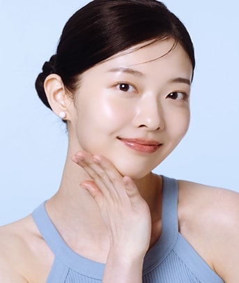 Woman holds tube of Ceramidin Moisturizer Cream