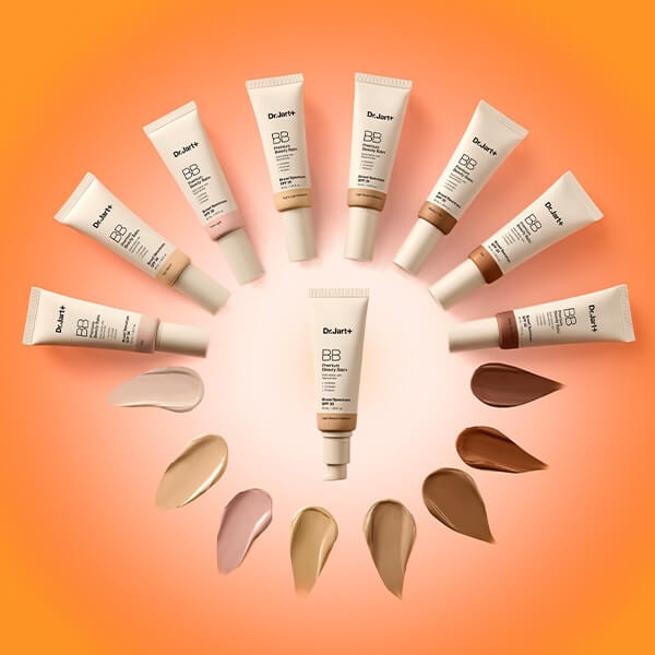 Six bottles of Dr.Jart+'s Premium BB Tinted Moisturizer with SPF 30 lean against peach backdrop