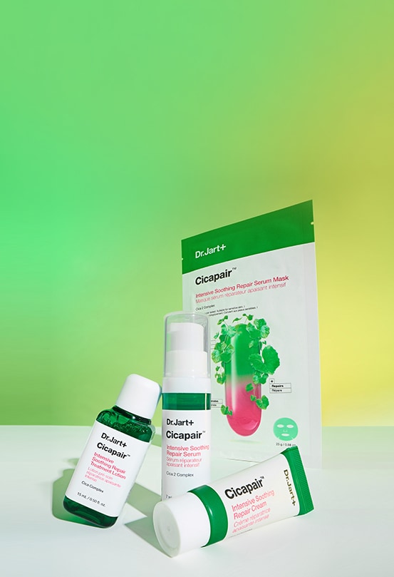 Cicapair™ serum mask, toner, moisturizer and serum are placed in front of a gradient green and yellow backdrop