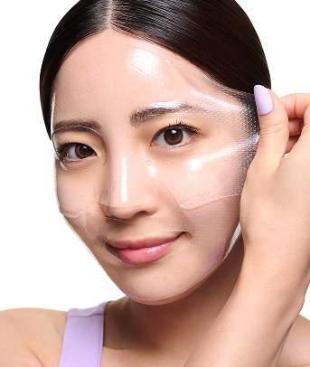 Woman holds tube of Ceramidin Moisturizer Cream