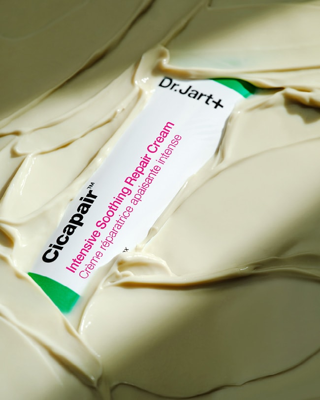 Cicapair Moisturizer Cream tube is submerged in the buttery, cream moisturizer.