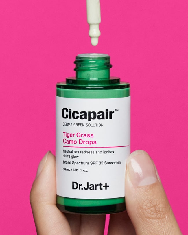 A hand is shown holding a bottle of the Cicapair Camp Drops with the applicator releasing droplets into the bottle.