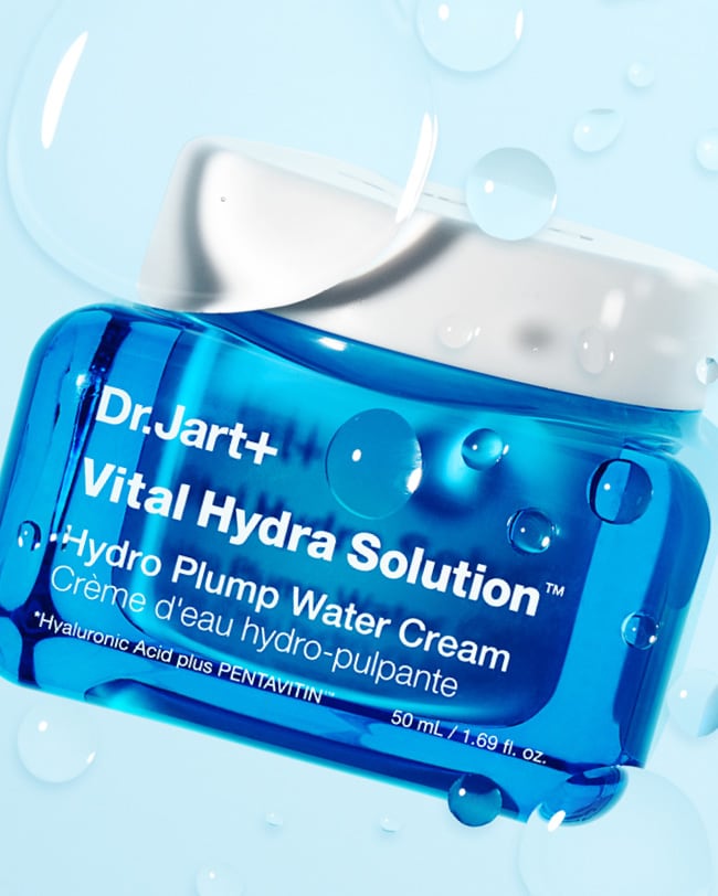 Tube of Cicapair Moisturizer Cream for sensitive skin balanced on artistic pink elements.