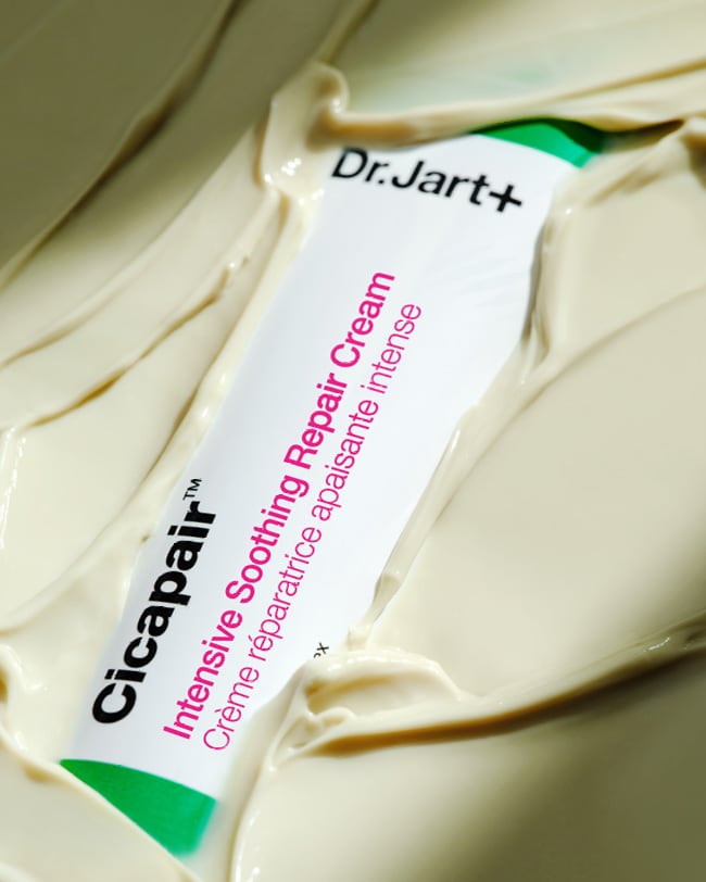 Cicapair Moisturizer Cream tube is submerged in the buttery, cream moisturizer.