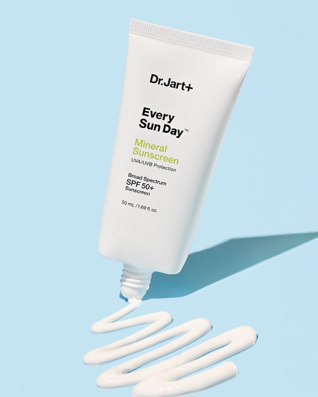 Every Sun Day Mineral Sunscreen bottle swirling back & forth the creamy sunscreen texture.