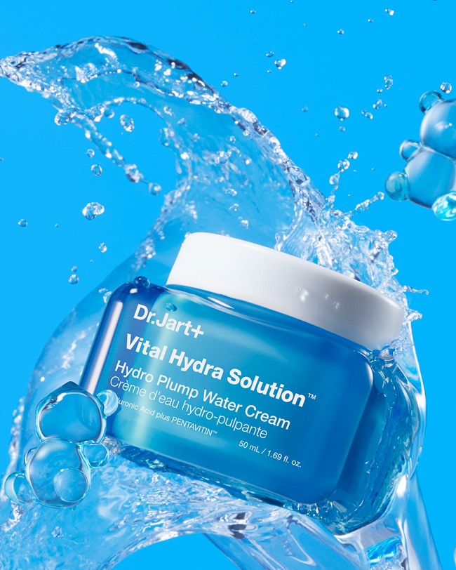 Tube of Cicapair Moisturizer Cream for sensitive skin balanced on artistic pink elements.