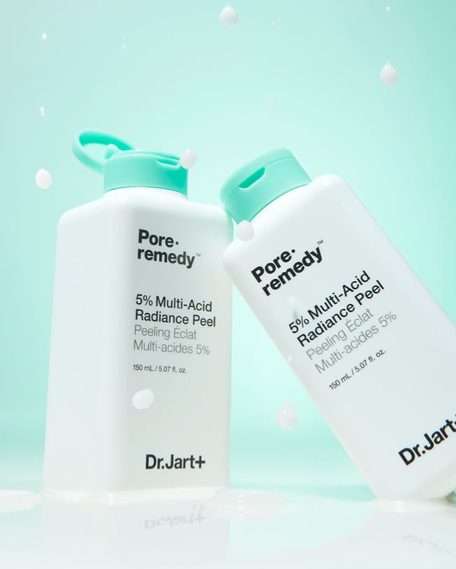 Two bottles of Pore Remedy™ 5% Multi-Acid Peel Exfoliator displayed on a light green background