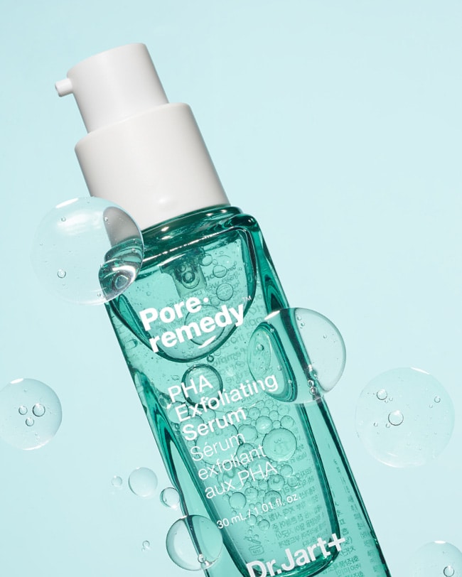 A bottle Pore remedy™ PHA Exfoliating Serum displayed on a light blue background