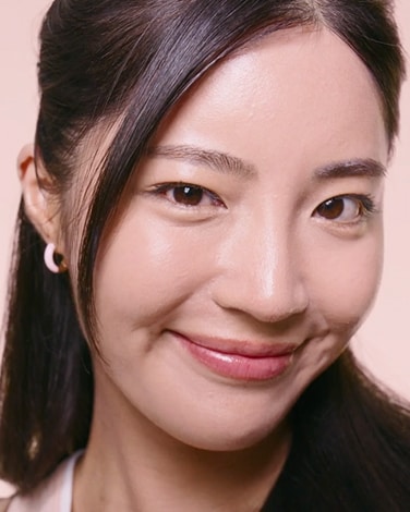 Two bottles of Premium BB Tinted Moisturizer are on a dark background showcasing the shade range thru the textures.