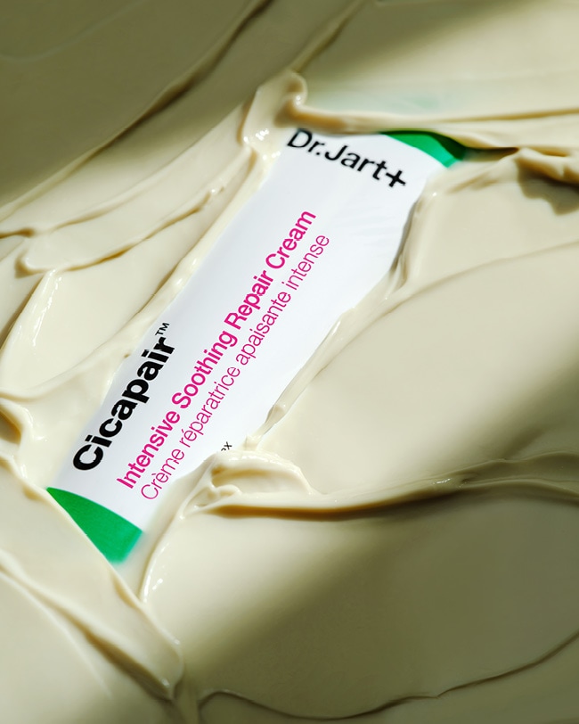 Cicapair Moisturizer Cream tube is submerged in the buttery, cream moisturizer.