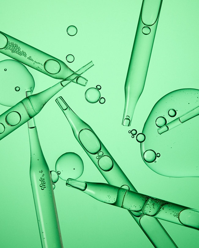 Cicapair Serum droplets are displayed fanned out on a green background. 
