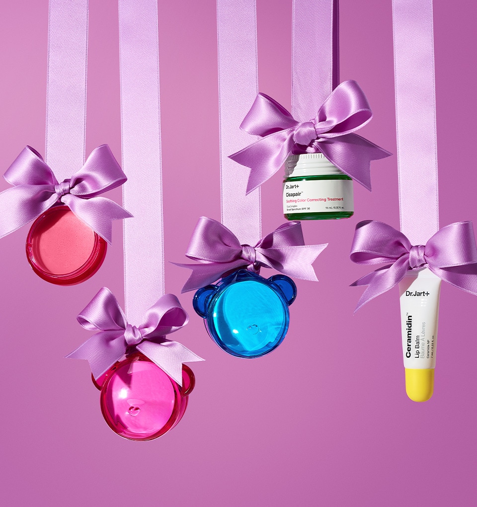Dr.Jart+ face masks and a tube of Ceramidin Moisturizer Cream are balanced on a light blue podium