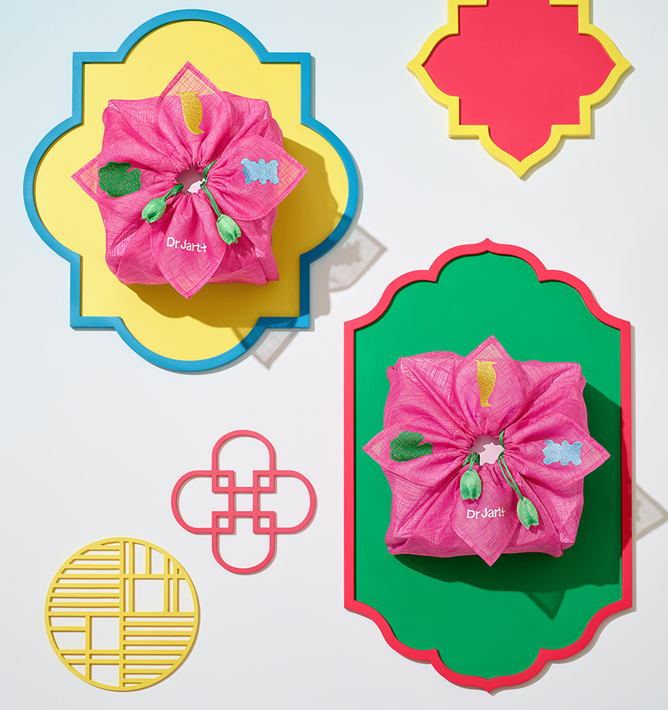 A brightly wrapped holiday ssam is tied elegantly around a gift.