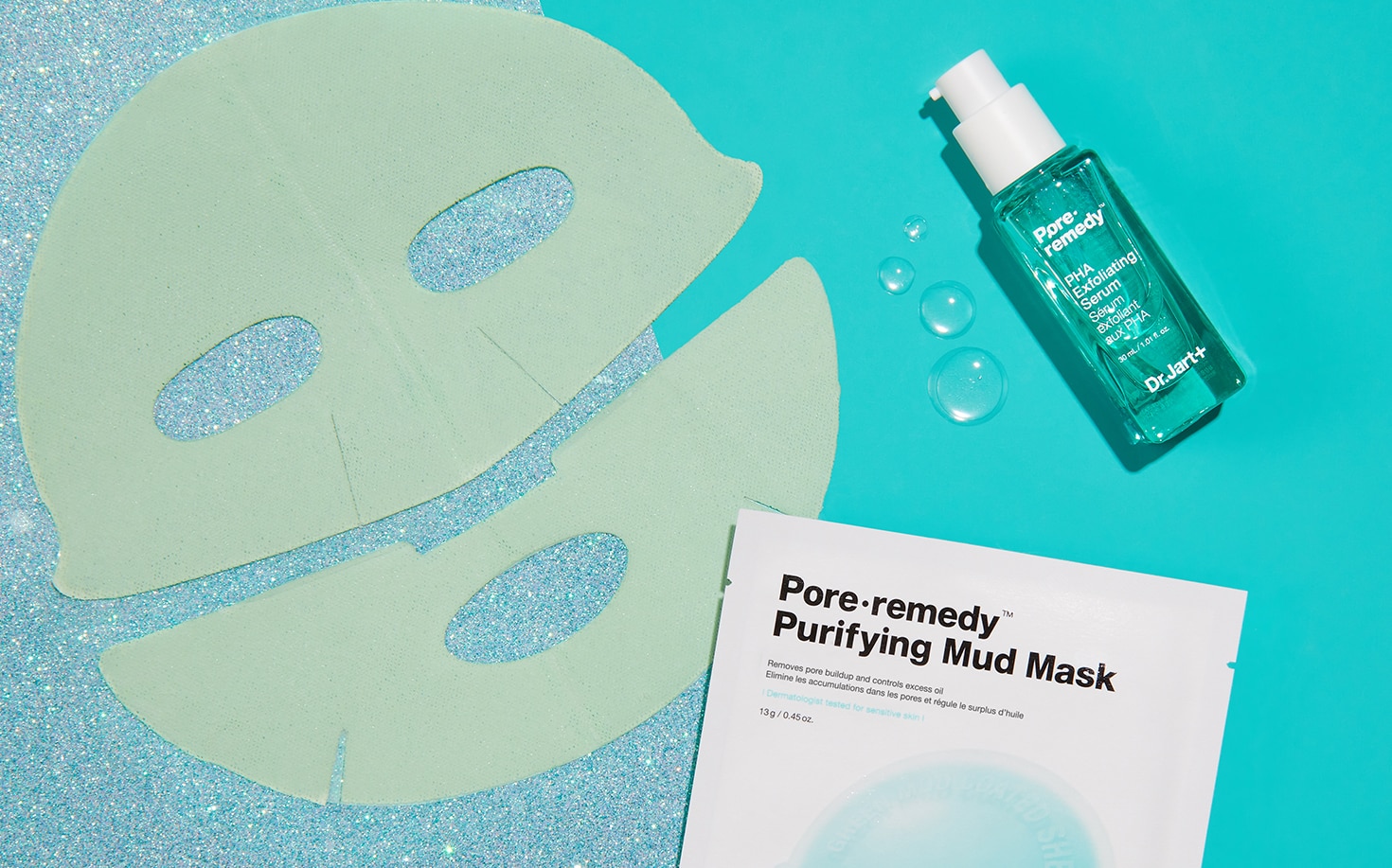Pore Remedy Serum and Pore Remedy Mud Mask components are laid out across an aqua background with droplets of liquid serum.