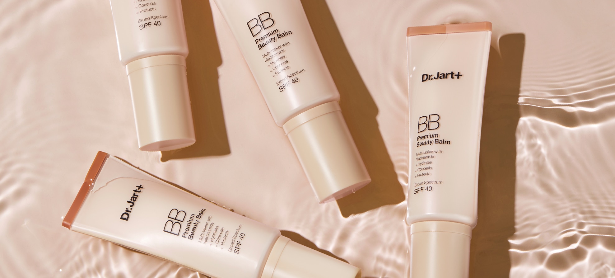 Four tubes of Premium BB Tinted Moisturizer floats in clear water