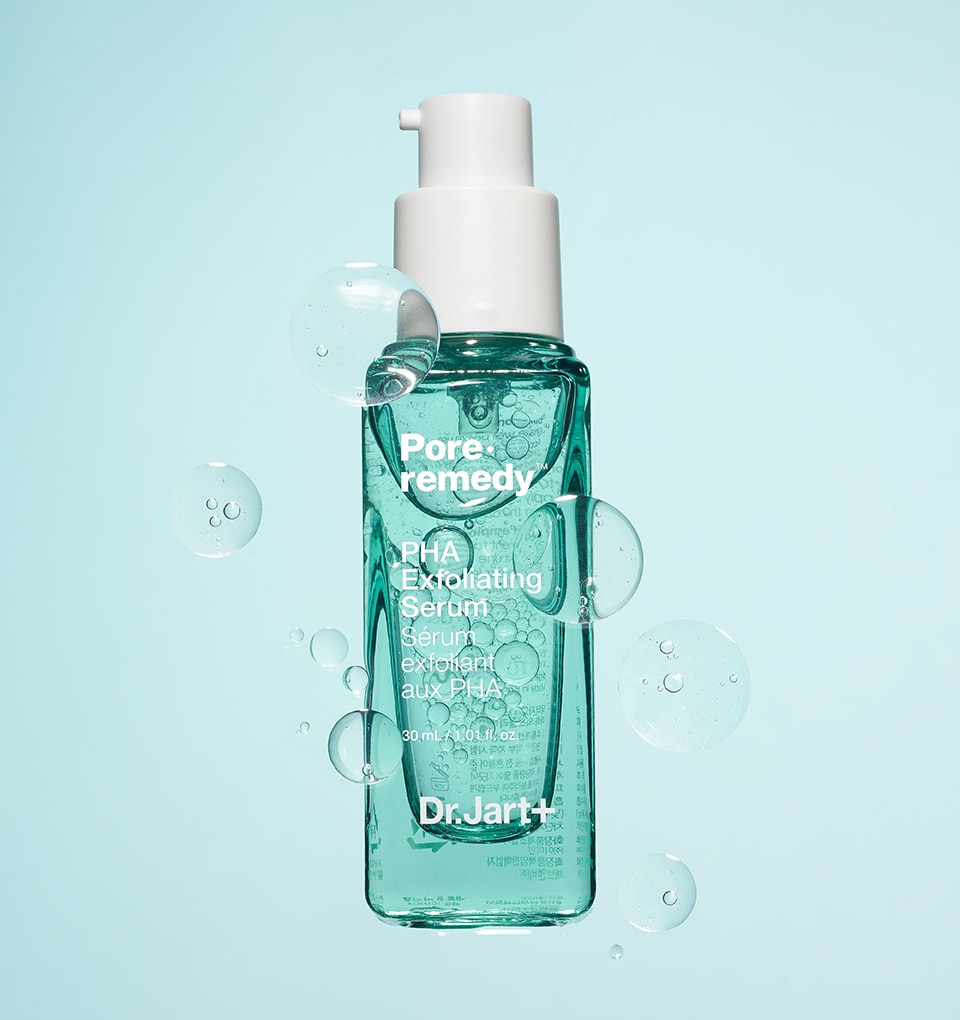 Pore Remedy Exfoliating Serum shows a close up view of the liquid exfoliator bottle. The clear blue liquid floats in the bottle